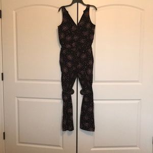 ladies jumpsuit. Black with flowers. Brand new.